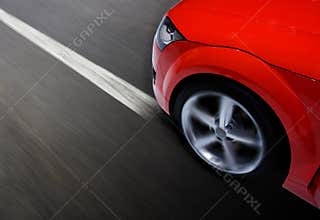 Fast sports car moving with blur