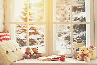 Christmas winter window with a book, a cup of hot tea