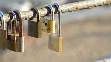 Padlocks with names in love at sunset with sea at background