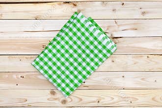 Green tablecloth on wooden table, top view