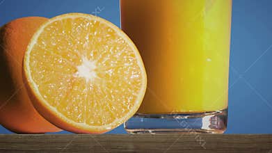 Pouring a glass of orange juice creating splash