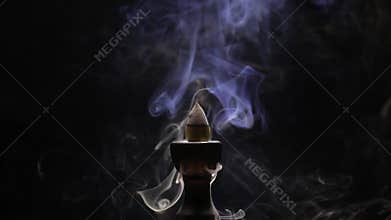 Aromatic cone smoldering in a ceramic stand