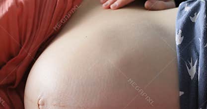 Close up pregnant woman playing with baby kicking from inside the womb belly mother tummy birth move love mom movement