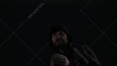 Bandit, hooligan or football fan with baseball bat attacks on dark background