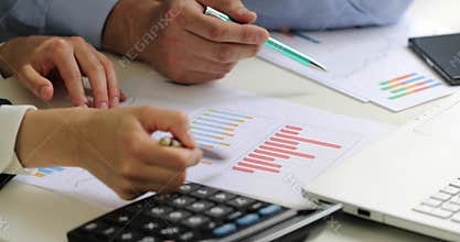 business colleagues discussing chart reports at office