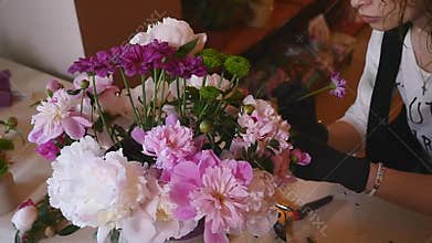 Florist hand make bouquets flowers in grey pot