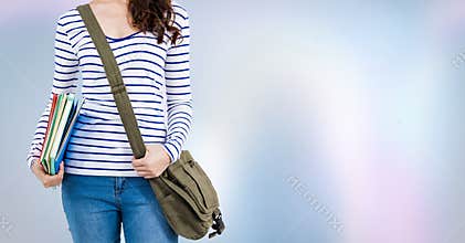 College student with books and bag against purple abstract background
