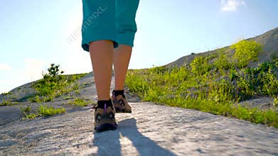 Legs of woman in tourist boots close-up. Hiking