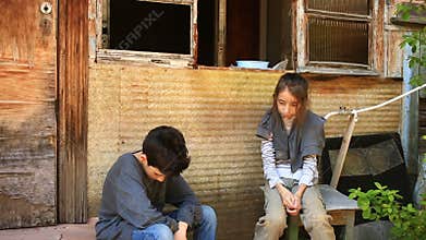 Refugee children against the background of bombed houses. War, earthquake, fire