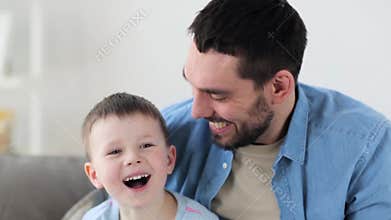 Happy father and little son laughing at home