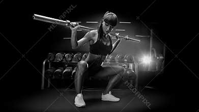 Black and white image of fit young woman in great shape lifting