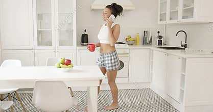 Side view of woman talking phone