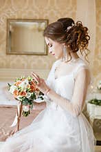 Brown-haired woman with classic wedding hair-style.