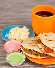 Closeup of a traditional delicious arepas, shredded chicken avocado and cheddar cheese and shredded beef with grated
