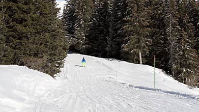 Skiers on piste going downhill