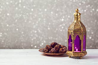 Lightened lantern on wooden table over bokeh background. Ramadan kareem holiday celebration
