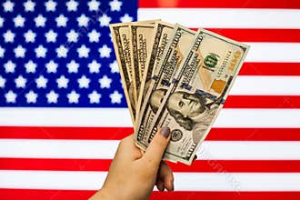 Man holding US Dollar bank note indicating market crash