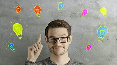 Clever creative man think gets an idea, which jumps up as symbolic colored cartoon animation shape lamps over his head