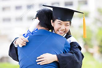 Student and family hug celebrating graduation