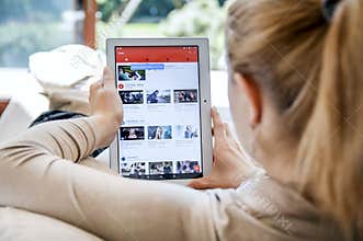 Woman launches Youtube application on Lenovo tablet