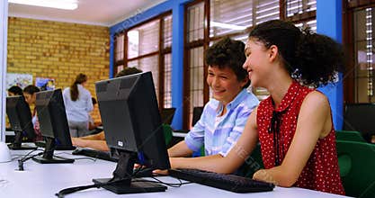 Students interacting with each other while using computer