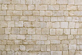 Old beige stone wall background texture