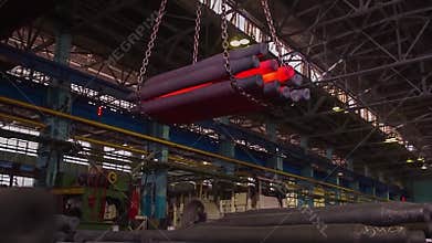 Manufacture of rails for trains and freight wagon, boxcars. Rail manufacturing plant. Stack of steel round bar - iron