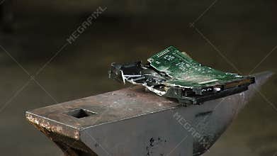 Man breaks the hard drive with a sledge heavy hammer, on the anvil. Slow motion Close-up have sound