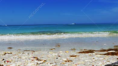 Beautiful blue beach low angle, Man crosses frame, 4K