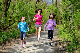 Family sport, happy active mother and kids jogging outdoors