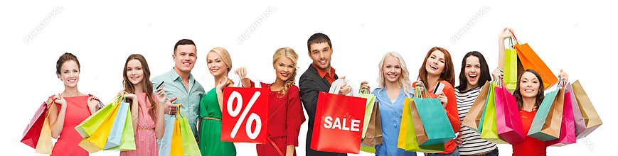 Happy people with sale sign on shopping bags
