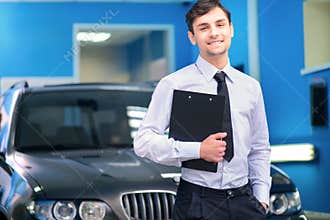 Car service manager posing with a clipboard