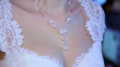 Brest of young bride with jewelry. necklace.