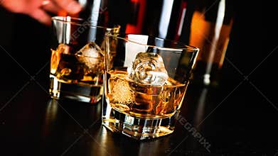Pouring whiskey on bar table lounge bar atmosphere