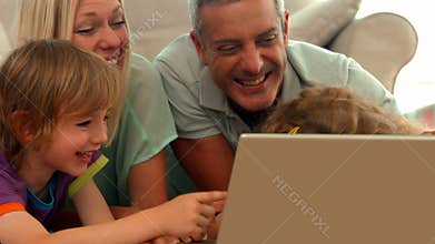 Happy family using laptop together