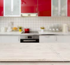 Wooden table on red modern kitchen bench interior background