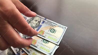 Pan of Woman Counting Out Hundreds of Dollars in Cash