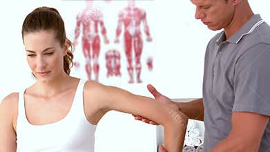 Physiotherapist moving patients arm