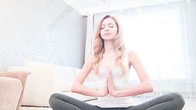 Young woman doing yoga and meditating