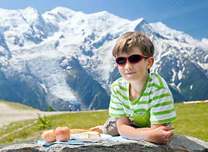 The boy has got pic nic on top of mountain
