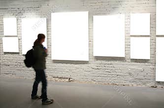 Girl walk through frames on brick wall