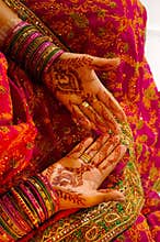 Indian wedding bride getting henna applied