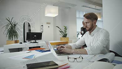 Attractive business man working at the office and looking at photo frame