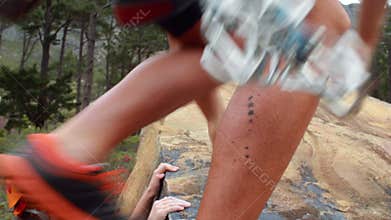Smiling couple rock climbing