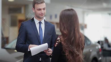 Salesman explaining contract conditions to woman