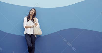 Stylish Cool Girl Against A Blue Wall