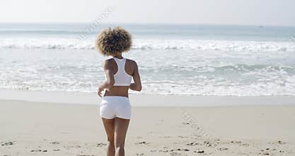Woman Jogging On The Beach