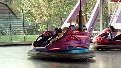 Happy mother with her daughter drive on bumper