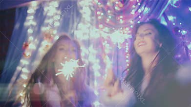 Two girls dancing with Christmas lights