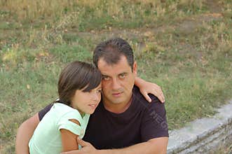 Father cuddling daughter